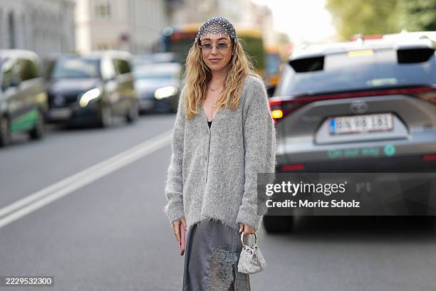 Sonia Lyson, attending the Munthe Show during Copenhagen Fashion Week SS26, is seen wearing a light gray Munthe mohair buttoned cardigan with V neck,...