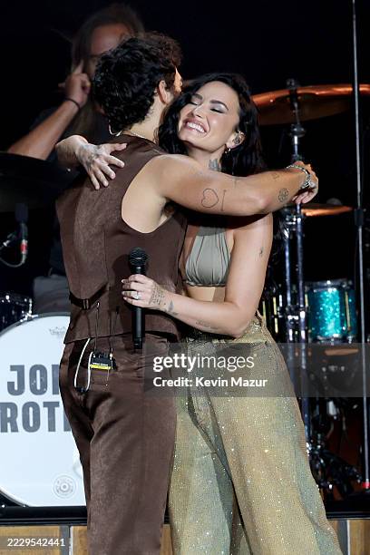 Joe Jonas and Demi Lovato perform onstage during the Jonas Brothers: JONAS20 Greetings From Your Hometown tour kick off at Met Life Stadium on August...