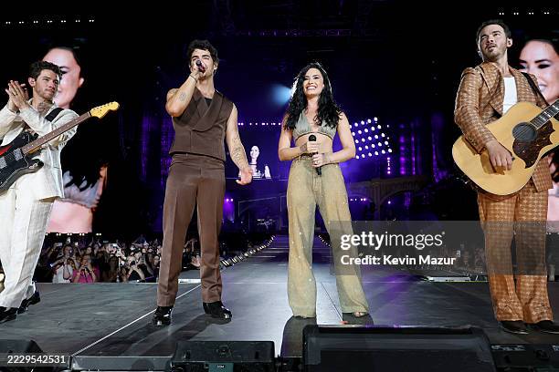 Nick Jonas, Joe Jonas, Demi Lovato, and Kevin Jonas perform onstage during the Jonas Brothers: JONAS20 Greetings From Your Hometown tour kick off at...