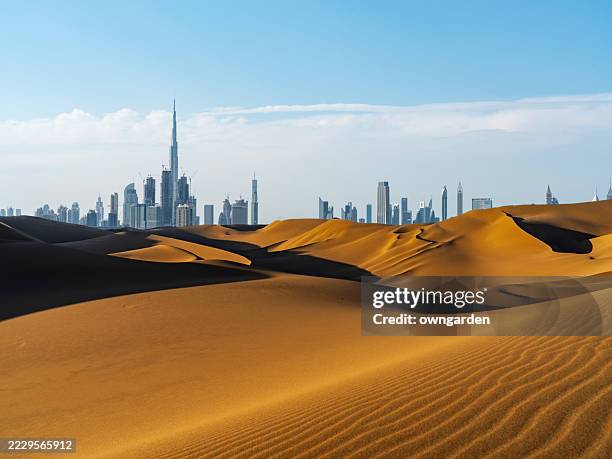 looking along desert towards the business district. - dubai bildbanksfoton och bilder