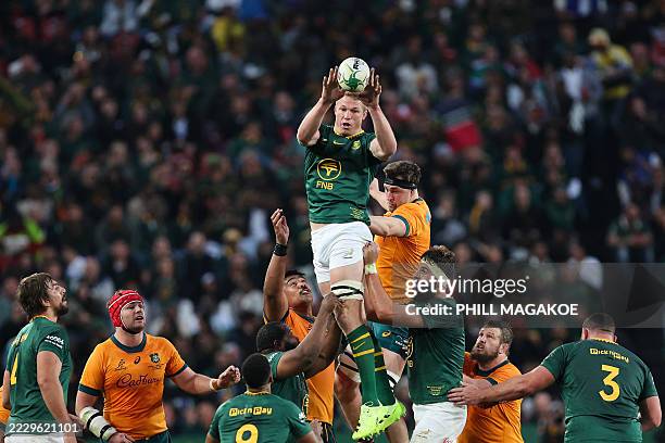 South Africa's loose forward Pieter-Steph du Toit passes the ball as he is lifted in the air during the Rugby Championship first round Test match...