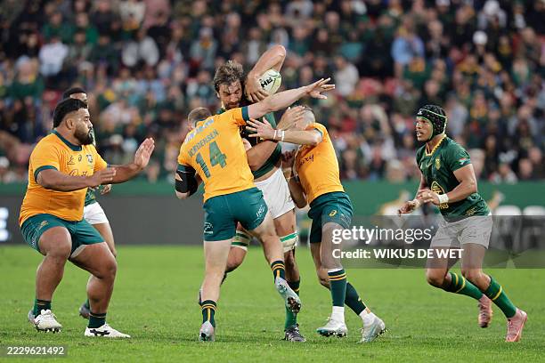 South Africa's lock Eben Etzebeth is tackled by Australia's wing Max Jorgensen during the Rugby Championship first round Test match between South...