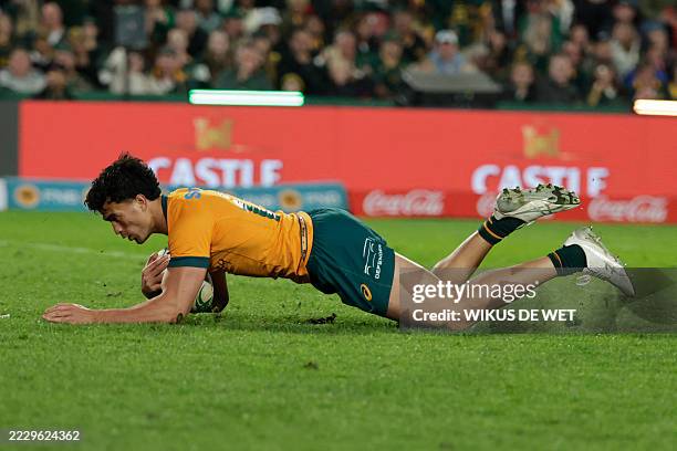Australia's centre Joseph Aukuso-Suaalii dives across the line to score a try during the Rugby Championship first round Test match between South...