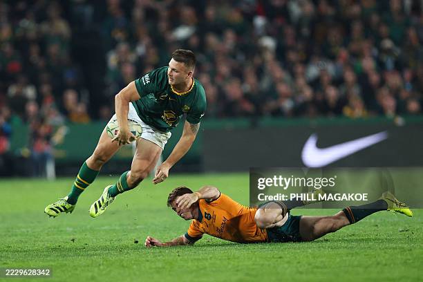 South Africa's centre Andre Esterhuizen jumps as he is tackled by Australia's fullback Andrew Kellaway during the Rugby Championship first round Test...