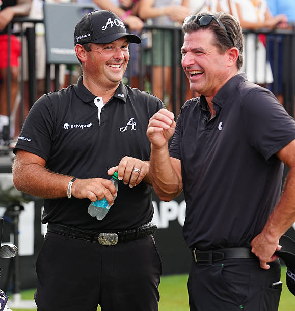 Golfer Patrick Reed on left talks with LIV CEO Scott O'Neil while waiting on the first tee during the second round of LIV Golf Indianapolis on August...