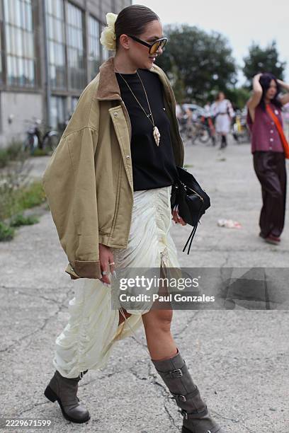 Guest is seen wearing a barn jacket with an ecru silk skirt at the Marimekko show. During Copenhagen Fashion Week day five on August 07, 2025 in...
