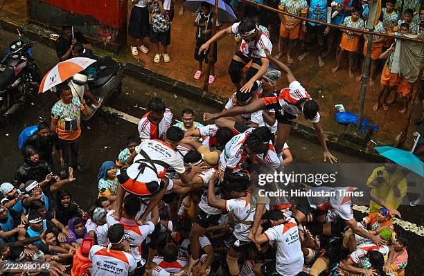 Govindas break the Dahi Handi by forming a human pyramid on the occasion of Gokulashtami festival at Dadar on August 16, 2025 in Mumbai, India.
