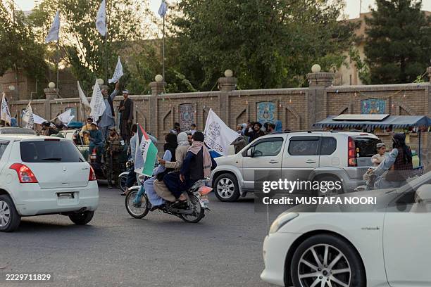 Convoy of Taliban security personnel parades during celebrations marking the fourth anniversary of the Taliban takeover in Herat, Afghanistan, on...