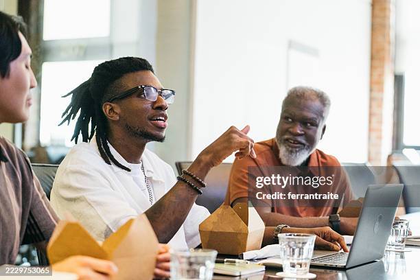 team lunch meeting in the boardroom - afro caribbean people stock pictures, royalty-free photos & images