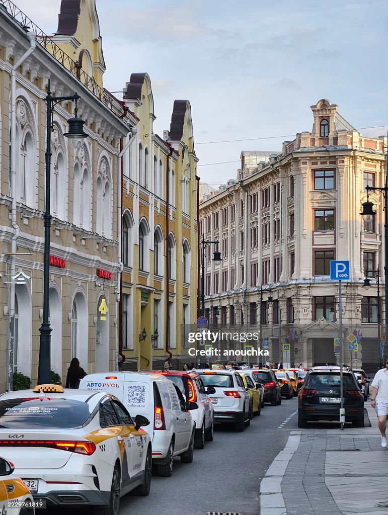 Charming historic narrow street with cars stuck in traffic jam, Moscow, Russia