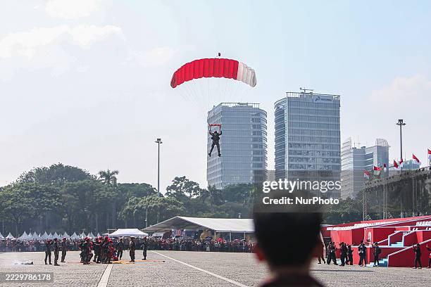 Indonesian Armed Forces soldiers perform a parachute jump at Indonesia's 80th Independence Day ceremony above the National Monument in Jakarta,...