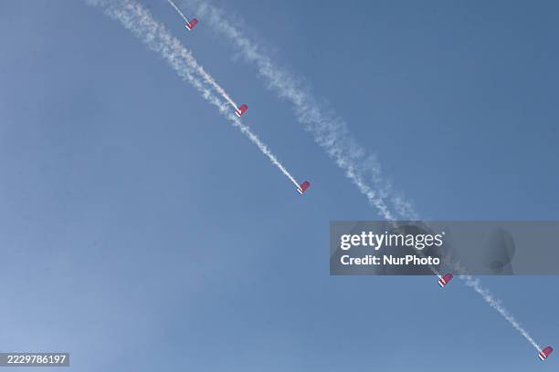 Indonesian Armed Forces soldiers perform a parachute jump at Indonesia's 80th Independence Day ceremony above the National Monument in Jakarta,...
