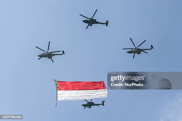 Indonesian Armed Forces helicopters unfurl the Indonesian flag during Indonesia's 80th Independence Day ceremony above the National Monument in...