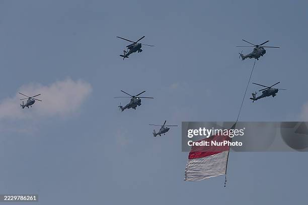 Indonesian Armed Forces helicopters unfurl the Indonesian flag during Indonesia's 80th Independence Day ceremony above the National Monument in...