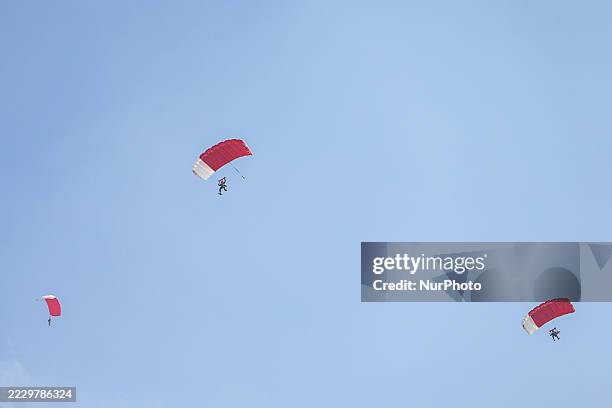 Indonesian Armed Forces soldiers perform a parachute jump at Indonesia's 80th Independence Day ceremony above the National Monument in Jakarta,...