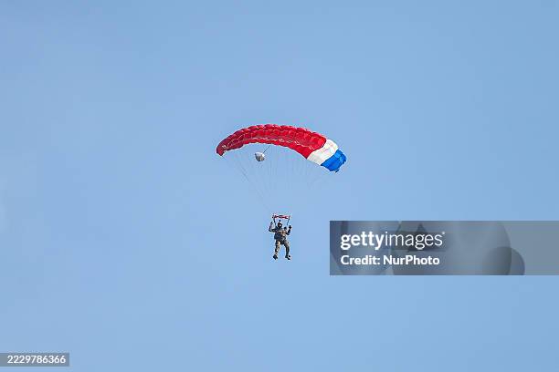 Indonesian Armed Forces soldiers perform a parachute jump at Indonesia's 80th Independence Day ceremony above the National Monument in Jakarta,...