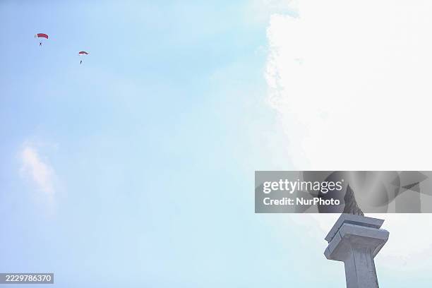 Indonesian Armed Forces soldiers perform a parachute jump at Indonesia's 80th Independence Day ceremony above the National Monument in Jakarta,...