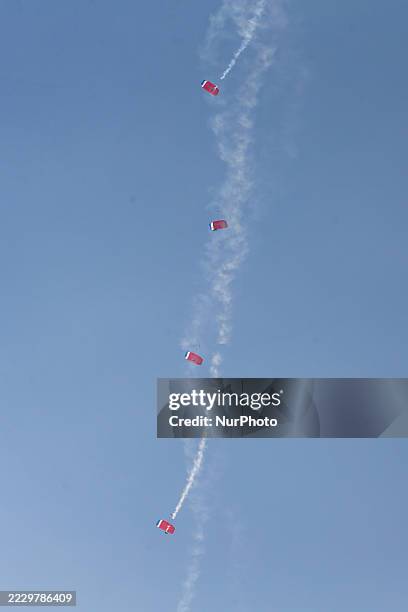 Indonesian Armed Forces soldiers perform a parachute jump at Indonesia's 80th Independence Day ceremony above the National Monument in Jakarta,...
