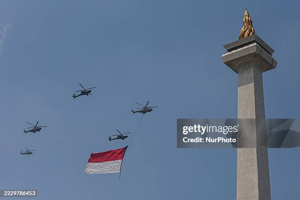 Indonesian Armed Forces helicopters unfurl the Indonesian flag during Indonesia's 80th Independence Day ceremony above the National Monument in...