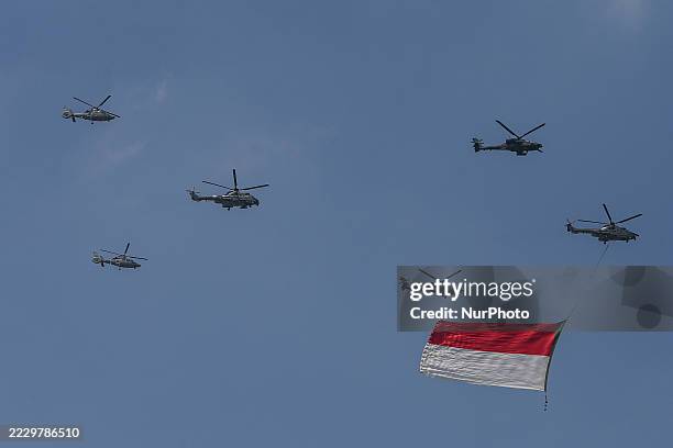 Indonesian Armed Forces helicopters unfurl the Indonesian flag during Indonesia's 80th Independence Day ceremony above the National Monument in...