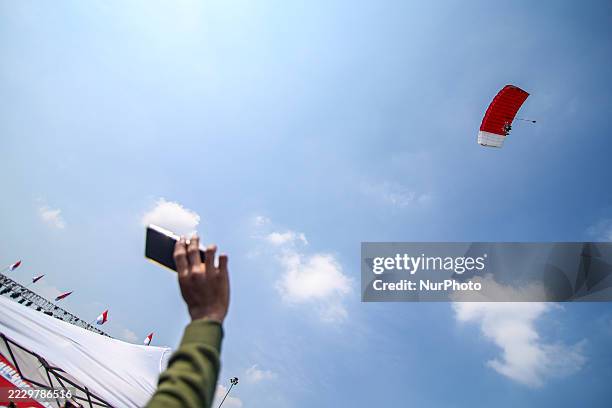 Indonesian Armed Forces soldiers perform a parachute jump at Indonesia's 80th Independence Day ceremony above the National Monument in Jakarta,...