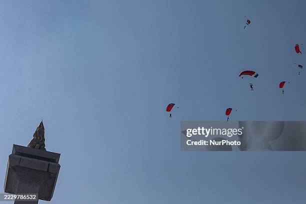 Indonesian Armed Forces soldiers perform a parachute jump at Indonesia's 80th Independence Day ceremony above the National Monument in Jakarta,...