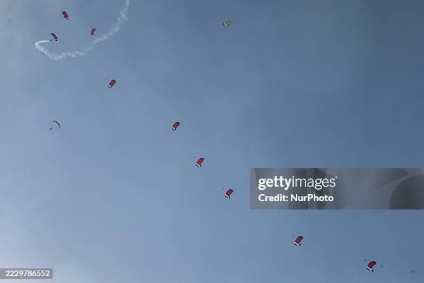 Indonesian Armed Forces soldiers perform a parachute jump at Indonesia's 80th Independence Day ceremony above the National Monument in Jakarta,...