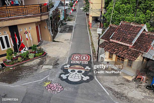 In Solo, Central Java, Indonesia, on August 13 people pass by a mural from the Japanese anime One Piece on a street. Citizens across various...