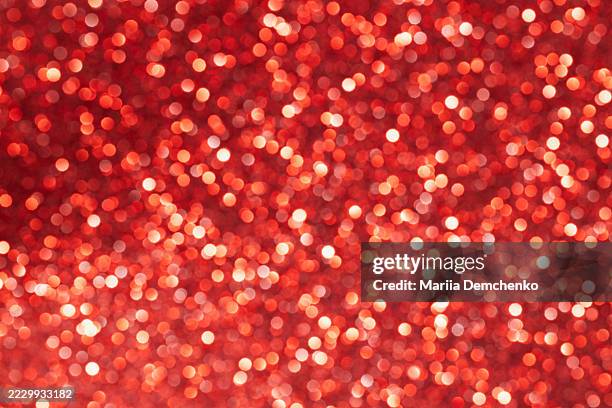 red sparkling glitter bokeh lights background - sequin stock pictures, royalty-free photos & images