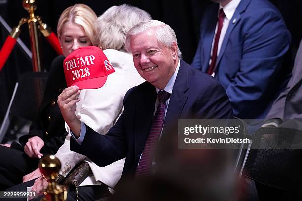Sen. Lindsey Graham holds up a hat that reads "Trump 2028" during an event at the Kennedy Center on August 13, 2025 in Washington, DC. U.S. President...