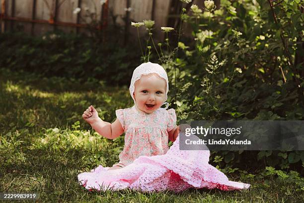 baby girl on blanket in garden - baby girls stock pictures, royalty-free photos & images
