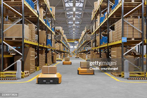 automated warehouse with robots transporting boxes - distributionslager bildbanksfoton och bilder