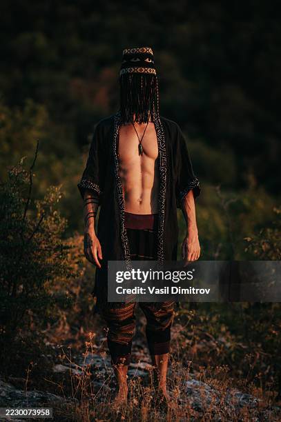 portrait photo of a shaman. mysterious man in the nature - traditional native american medicine stock pictures, royalty-free photos & images