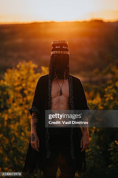 portrait photo of a shaman. mysterious man in the nature - traditional native american medicine stock pictures, royalty-free photos & images