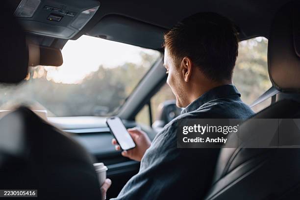 man using ai navigation app during road trip - front passenger seat stock pictures, royalty-free photos & images
