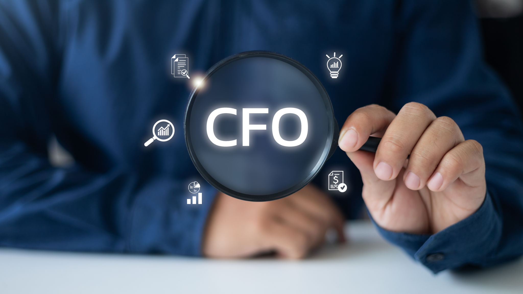 Businessman holding a magnifying glass, highlighting the CFO role with financial icons, representing executive leadership in corporate finance, strategy, and accounting. Businessman holding a magnifying glass, highlighting the CFO role with financial icons, representing executive leadership in corporate finance, strategy, and accounting.