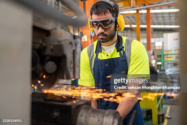 male worker grinding product - foundry stock pictures, royalty-free photos & images