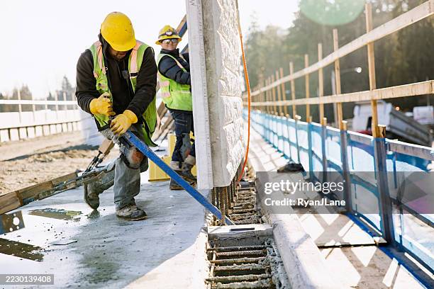 man and woman construction workers assembling wall on lightrail concrete platform - concrete work stock pictures, royalty-free photos & images