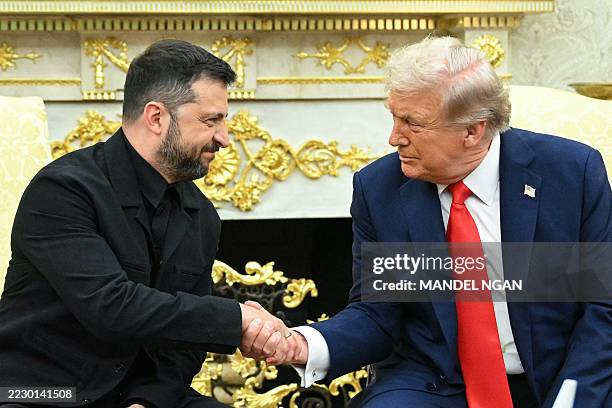 Ukrainian President Volodymyr Zelensky and US President Donald Trump shake hands during a meeting in the Oval Office of the White House in...