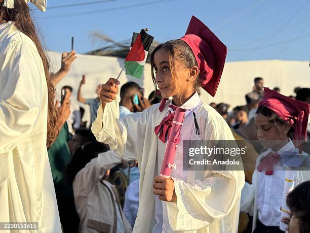 Palestinian children attend their graduation ceremony at The Vefa Orphan Village, operating in the Mawasi area west of Khan Younis, Gaza on August...
