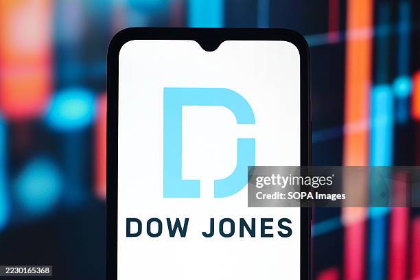 In this photo illustration, the Dow Jones company logo is seen displayed on a smartphone screen.