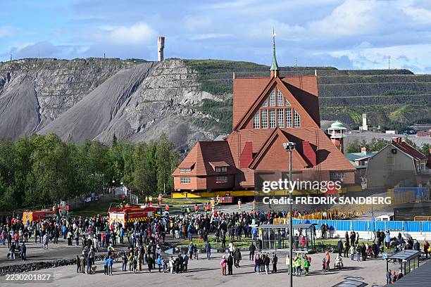 People gather to watch the moving of the wooden Kiruna Church, in Kiruna, Sweden on August 19, 2025. The church is being moved five kilometers to the...
