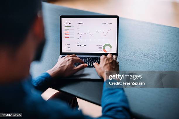 business analysis on laptop showing financial growth and analytics graphs - afro caribbean people stock pictures, royalty-free photos & images
