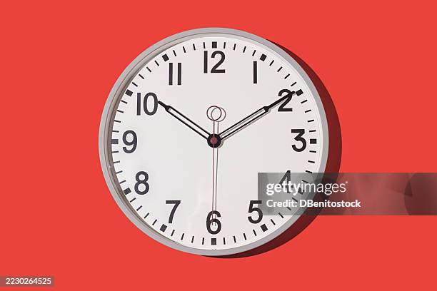 wall clock showing 10:10 on a red background. time, hour, minute, second, measuring instrument. - clock hand stock pictures, royalty-free photos & images
