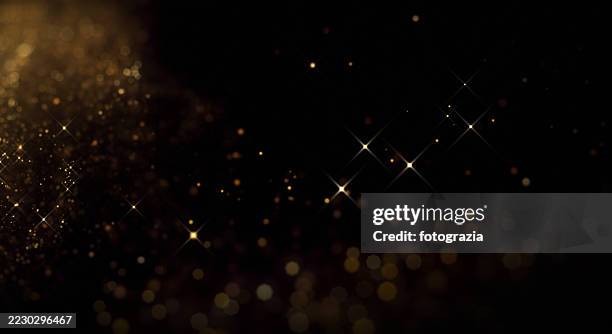 golden glitter sparkle background with light effects and copy space - blinking stock pictures, royalty-free photos & images