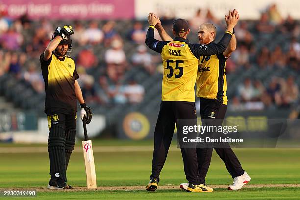 James Harris of Glamorgan celebrates with team-mate Asa Tribe after taking the wicket of Jack Taylor of Gloucestershire, caught by Will Smale during...