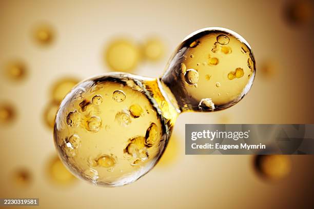 golden molecular fusion in abstract fluid form - facial oil stock pictures, royalty-free photos & images