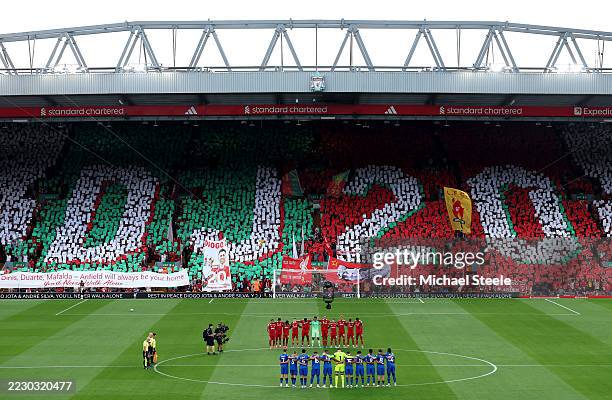 Players, match officials and fans take part in a minute's silence as a fan mosaic depicting "DJ20" is displayed in memory of Diogo Jota and his...