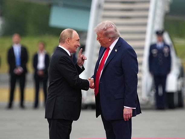 President Donald Trump greets Russian President Vladimir Putin as he arrives at Joint Base Elmendorf-Richardson on August 15, 2025 in Anchorage,...