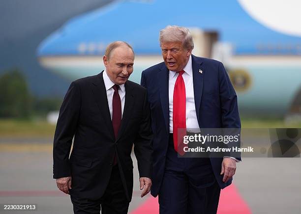 President Donald Trump walks with Russian President Vladimir Putin as they arrives at Joint Base Elmendorf-Richardson on August 15, 2025 in...
